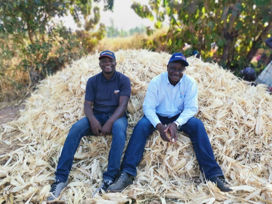 two african farmers smiling